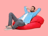Man Relaxing on a Red Bean Bag