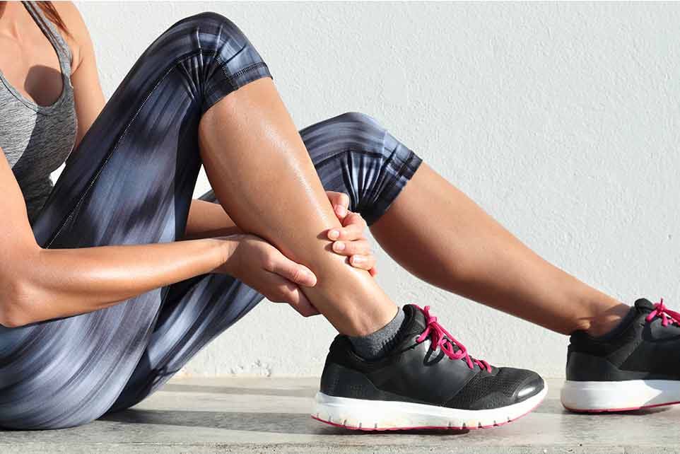 Woman Applying CBD Muscle Rub to Calf After Running